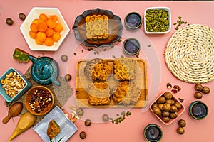 Flat lay mid autumn festival colorful food and drink on sweet pink background