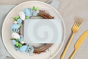 Flat lay with mockup menu and easter decoration. Easter wreath and blank card