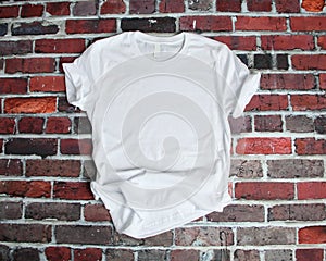 Flat lay mockup of white tee shirt on brick background