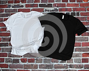 Flat lay mockup of white tshirt and black tshirt on brick background