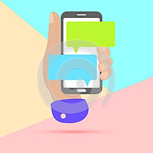 flat lay modern minimal hand holding mobile phone with chat message notifications with shadow on pastel colored blue and pink