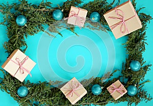 Flat lay new year cristmas craft boxes, balls and pine tree on aqua blue