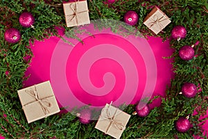 Flat lay new year cristmas craft boxes, pink magenta balls and pine tree on pink