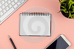 Flat lay office desk with note pad and computer keyboard