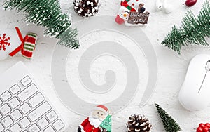 Flat lay Office desk table with computer wireless mouse and keyboard and Christmas decoration toys and ornaments on rustic white