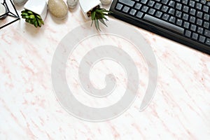 Flat lay office marble desk with phone, keyboard and notebook copy space background