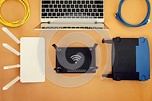 Flat lay Office table with wifi router, computer and supplies top view