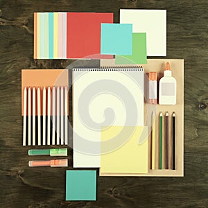 Flat lay office tools and supplies. Education background with stationery on wood. Flat design of creative office workspace, workpl