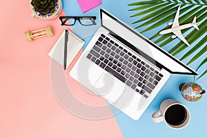 Flat lay office workspace with blank laptop, clipboard, top view laptop background and copy space on pink and blue background,