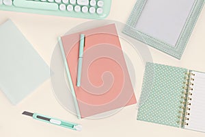 Flat lay old rose book and green stationery