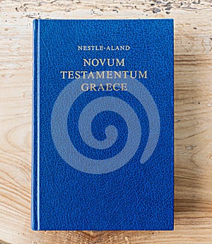 Flat lay open Bible, Greek New Testament. On wooden background. Baselland, Switzerland 12.05.2019