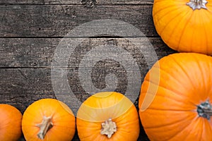 Flat lay, orange Pumpkins on a wooden Table, copyspace