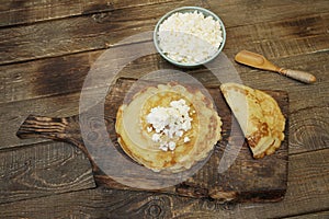Flat lay pancakes with cottage cheese on wooden rustic background