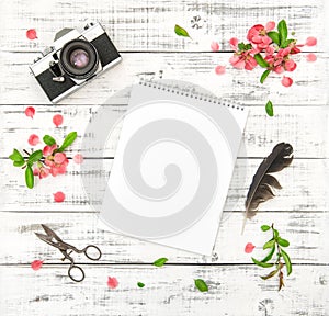 Flat lay paper sketchbook photo camera pink spring flowers photo