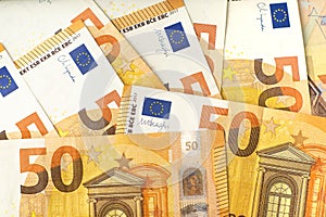 Flat lay pattern of 50 euro cash banknotes. Money background for financial and economy topics.