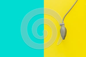 Flat lay: pear of blood pressure monitor, tonometer. Bright blue yellow background. Device for measurement of pulse, heart rate
