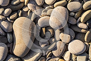 Flat lay of pebbles pattern on the sea shore