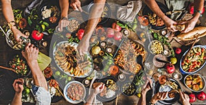 Flat-lay of peoples hands and Turkish foods over rustic table