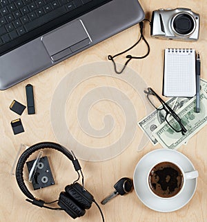 Flat lay of personal stuff, notebook computer,cards, coffee, money, camera photo and other. Flat design and top view on desk as fr