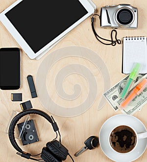 Flat lay of personal stuff, tablet computer,cards, coffee, money, camera photo and other. Flat design and top view on desk as fram