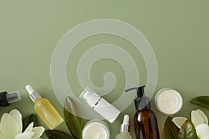 Flat lay photo of amber pump bottle, cream jar, dropper bottles and tropical leaves