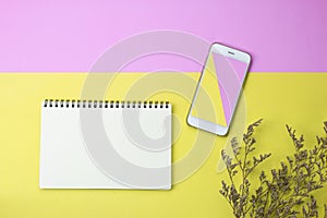 Flat lay photo of blank notebook, smart phone and dry flowers photo