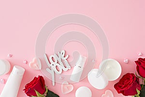 Flat lay photo of cosmetic bottles without label, red roses, heart shaped candles and inscription love you