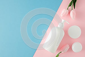 Flat lay photo of cosmetic tubes without label, cream jars and spring flowers