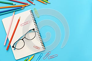 Flat lay photo of office desk with colorful pencil, Paper clip, Note book, Glasses, Top view of the copy space