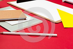 Flat lay photo of office desk with notebook and supplies top view