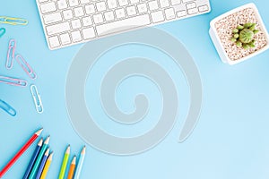 Flat lay photo of office desk with pencil and keyboard ,Top view workpace on blue background and copy space