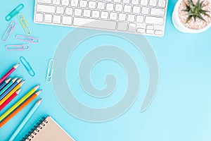 Flat lay photo of office desk with pencil and keyboard ,Top view workpace on blue background and copy space