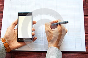 Flat lay photo of office desk with smartphone