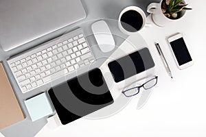 Flat lay photo of Office table with keyboard, notebook, digital tablet, mobile phone, Pencil, eyeglasses on modern two tone