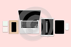 Flat lay photo of office table with laptop computer, digital tablet, mobile phone and accessories. on modern pink tone background.