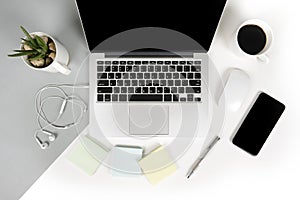 Flat lay photo of Office table with laptop computer, notebook, digital tablet, mobile phone on modern two tone background