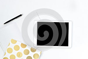 Flat lay photo of office white desk with tablet and gold notebook copy space background