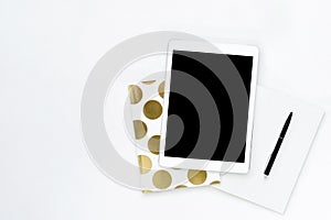 Flat lay photo of office white desk with tablet and gold notebook copy space background
