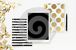 Flat lay photo of office white desk with tablet and gold notebook copy space background serpentine