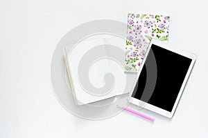 Flat lay photo of office white desk with tablet and open notebook copy space background