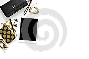 Flat lay photo of stylish office white desk with wallet, Women`s jewelry, tablet and gold notebook copy space background