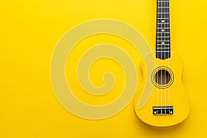 Flat lay photo of yellow ukulele with copy space