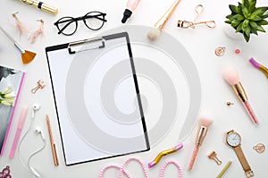 Flat lay pink composition with blank clipboard, cosmetics, makeup tools, on white background. beauty, fashion, party and