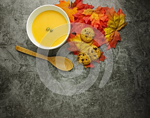 Flat lay pumpkin soup on grey background