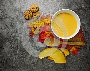 Flat lay pumpkin soup on grey background