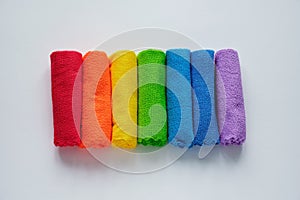 Flat lay rainbow towels, row of multicolored cotton towels isolated on white