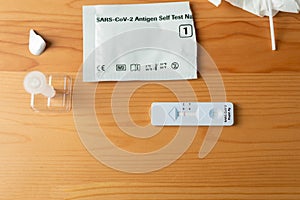 Flat lay with rapid antigen test with negative result. Health and medicine concept.