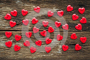 Flat lay of red buttons Valentines heart on old wooden, above vi