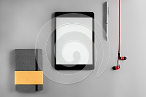 Flat lay with red headphones iPad and notebook