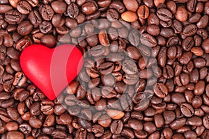 Flat lay of red heart on the background of coffee beans.Ð¡oncept of love, holidays